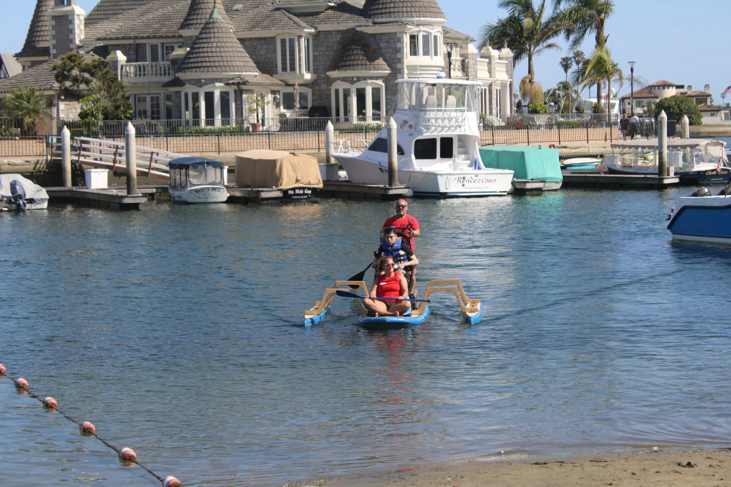 An adaptive paddler and AFF support crew enjoying the water together