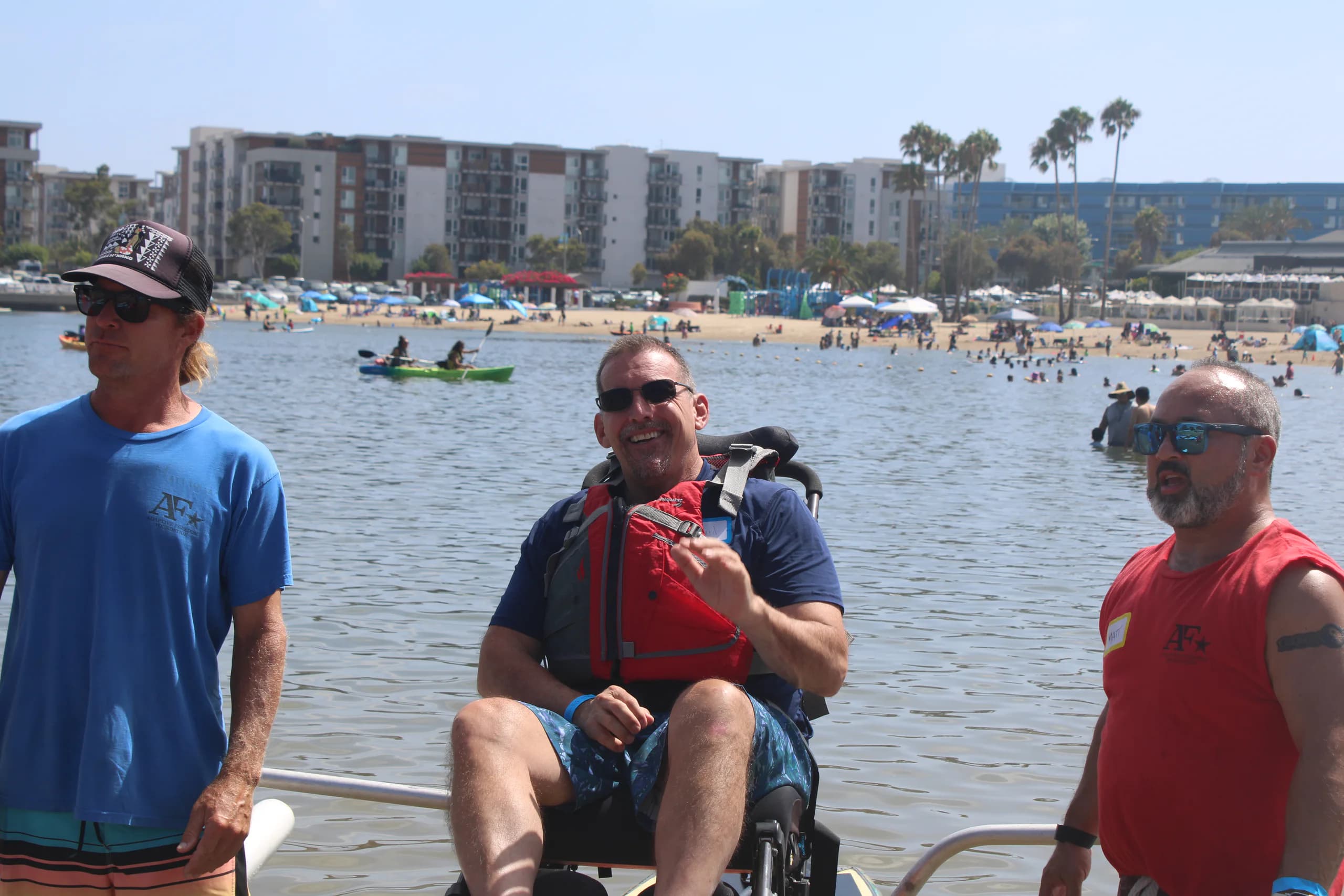 An AFF crew member helping a wheelchair user at the shoreline