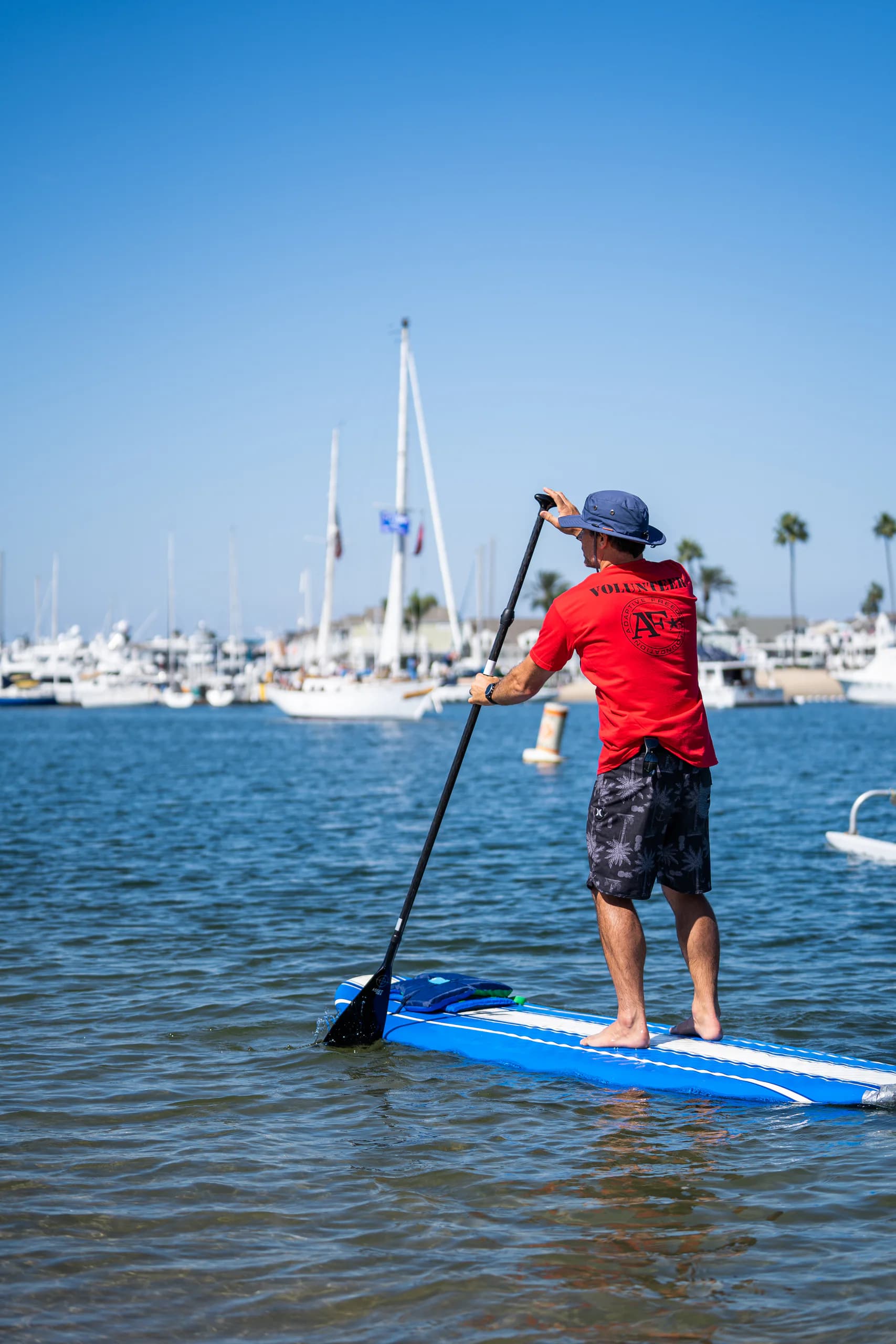 An AFF volunteer paddling on calm blue water