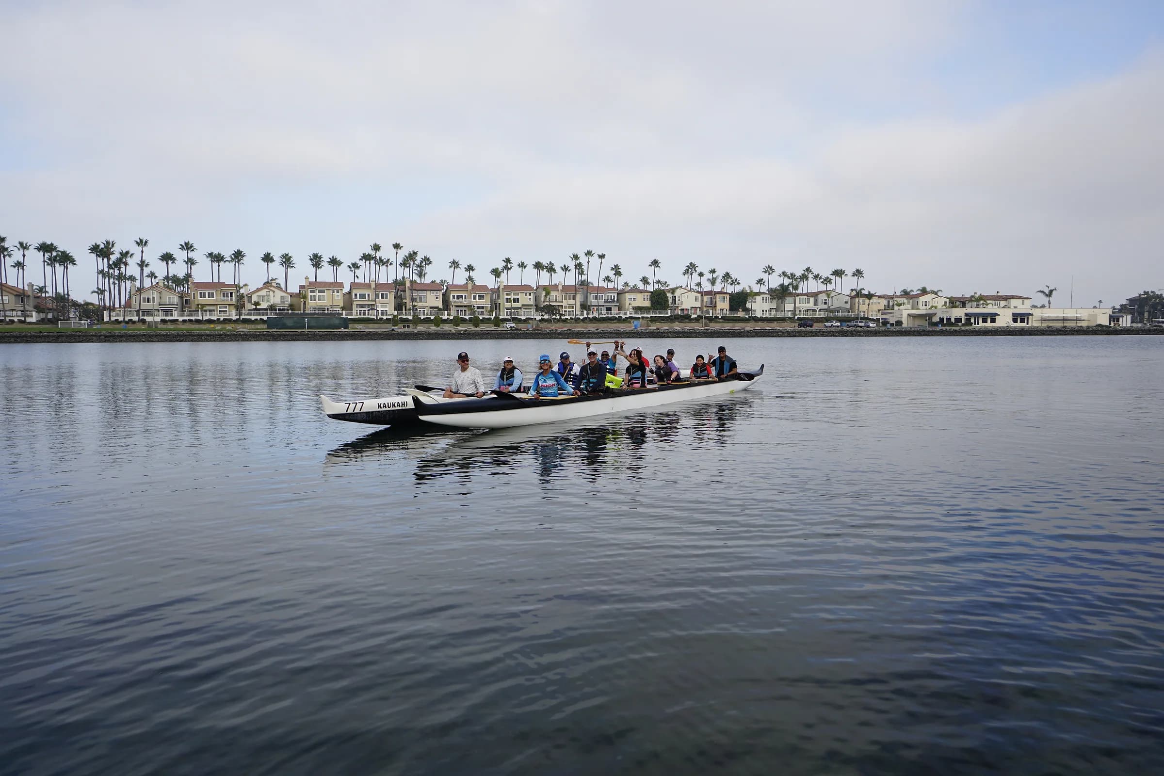 A full adaptive paddling crew crossing calm water together