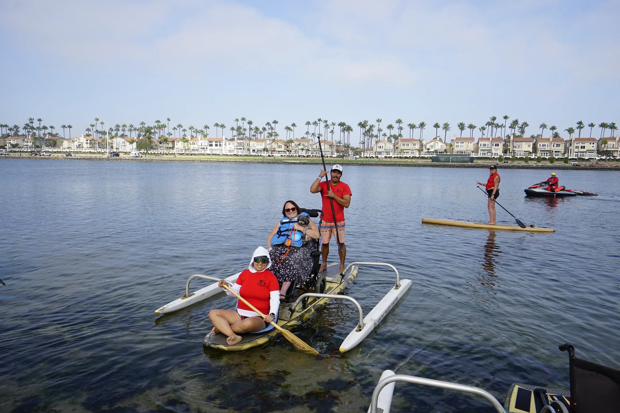 Several adapted boards moving together near the Long Beach shoreline