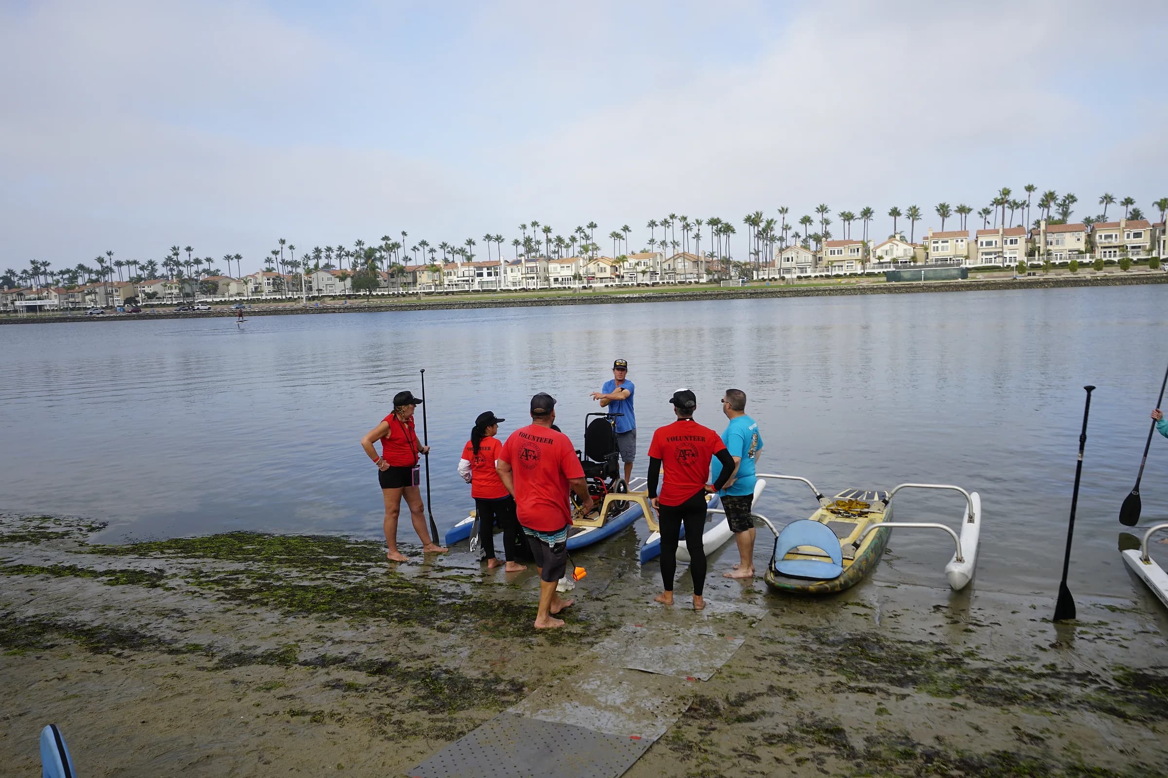 AFF volunteers preparing an adaptive board together at the shoreline