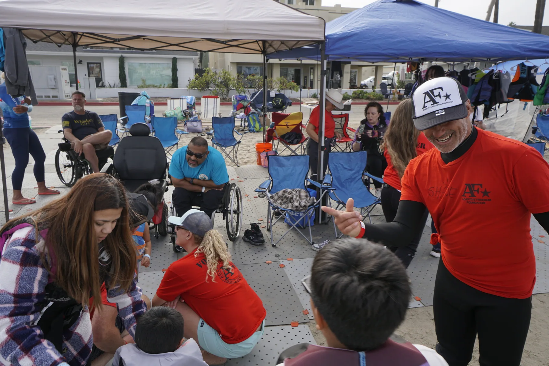 AFF volunteers welcoming families and community members beneath event tents