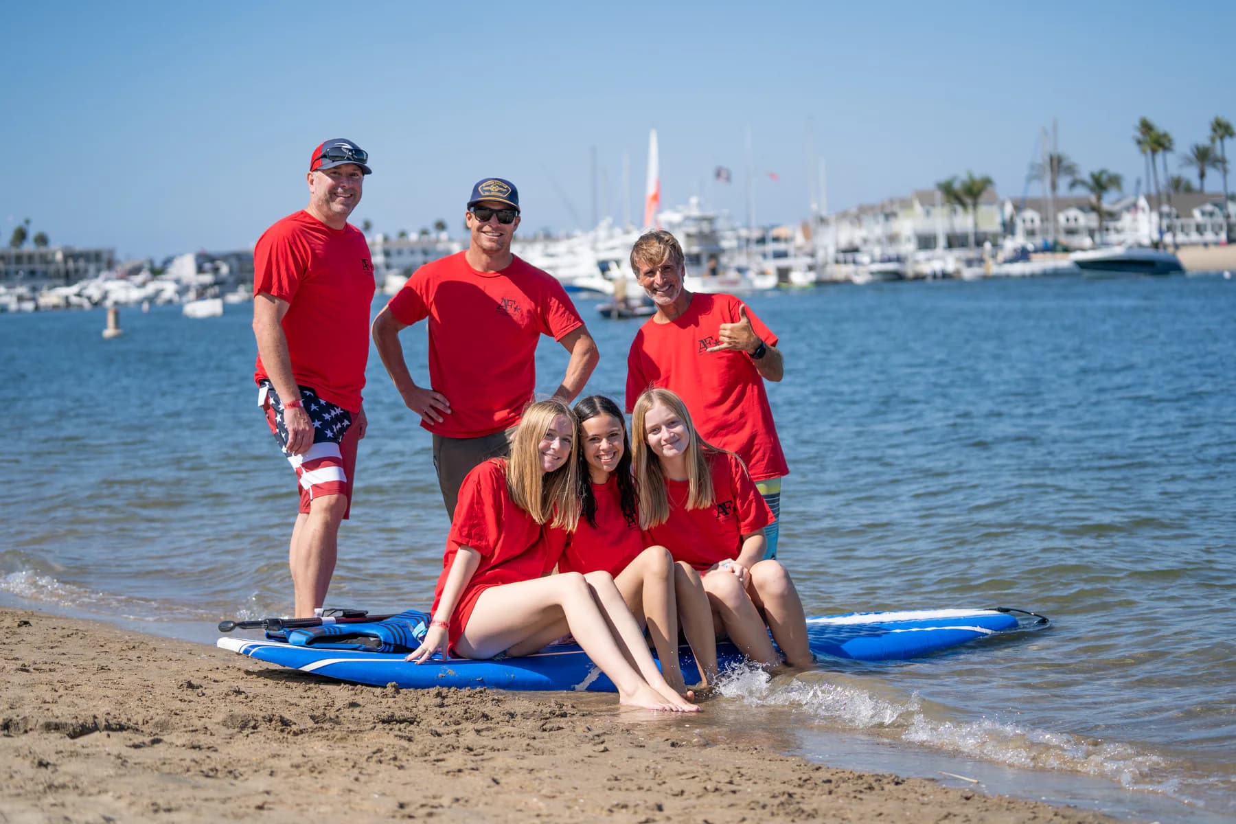 AFF volunteers gathered with paddleboards at the shoreline